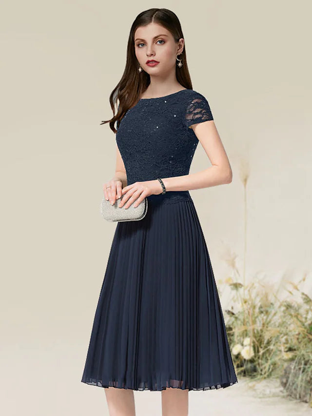 Front view of an A-line chiffon cocktail dress with short sleeves and jewel neck.