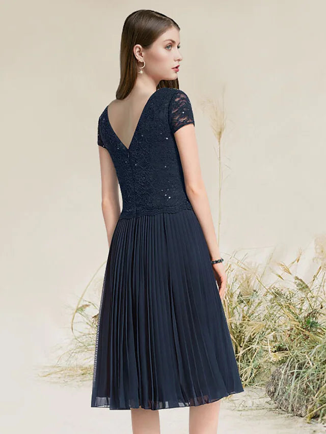 Side view of an A-line chiffon homecoming dress, featuring a tea length skirt.