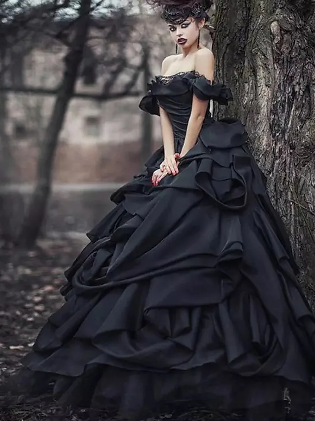 Black ball gown wedding dress with off-shoulder neckline, lace bodice, and court train.