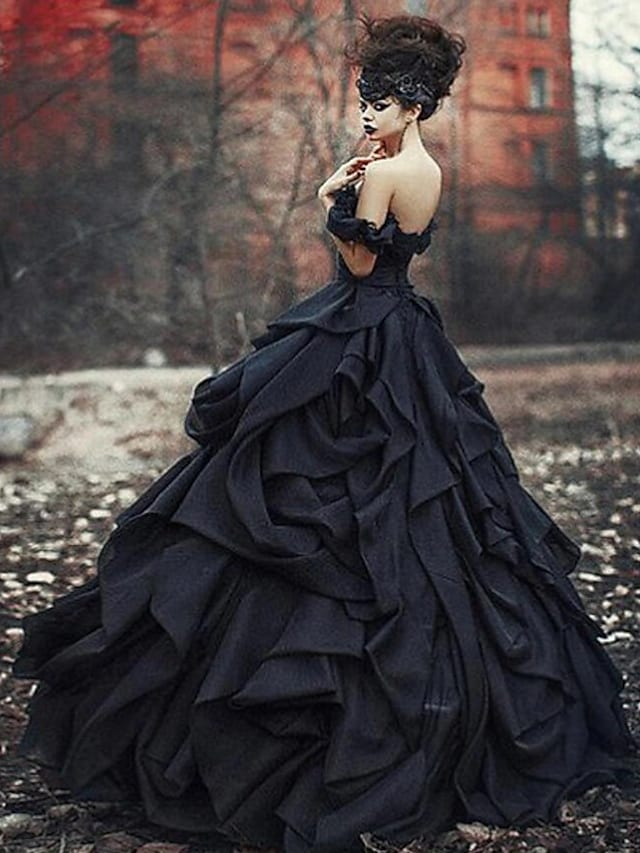 Back view of the black lace tulle wedding dress with a flowing court train.