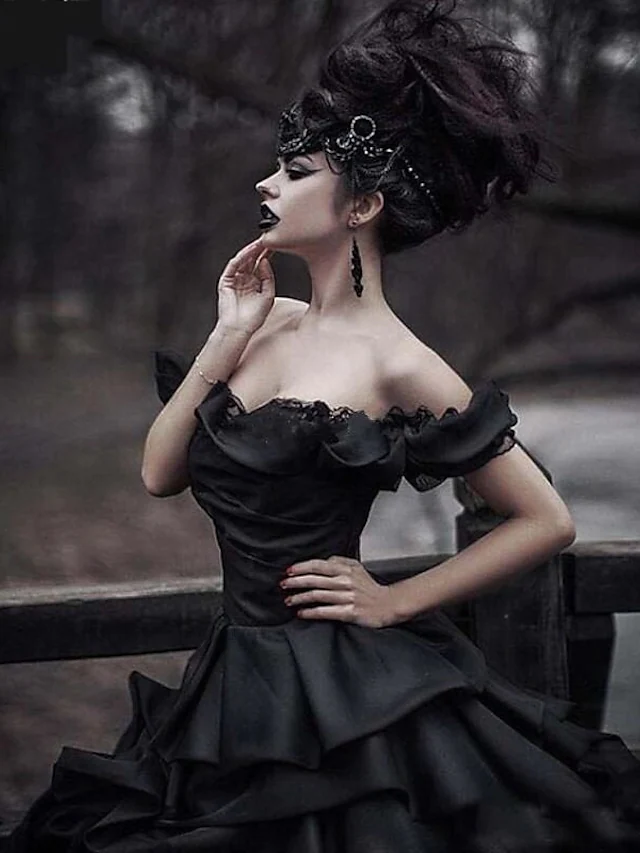 Elegant black ball gown wedding dress with short sleeves and cascading lace.
