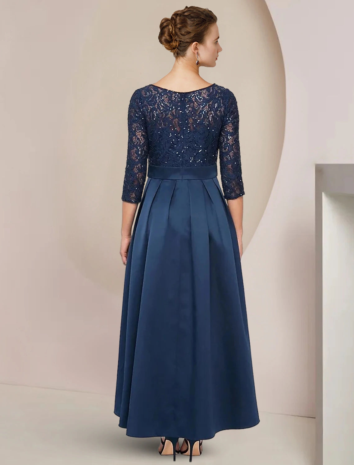 Side view of a woman wearing an A-Line lace and taffeta dress.