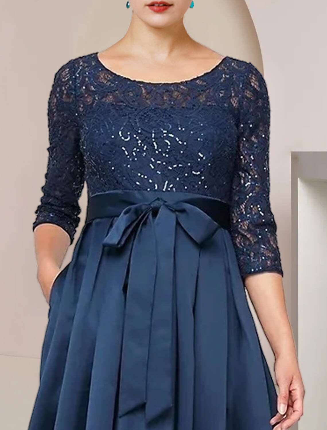 Back view of the asymmetrical tea length wedding guest dress.