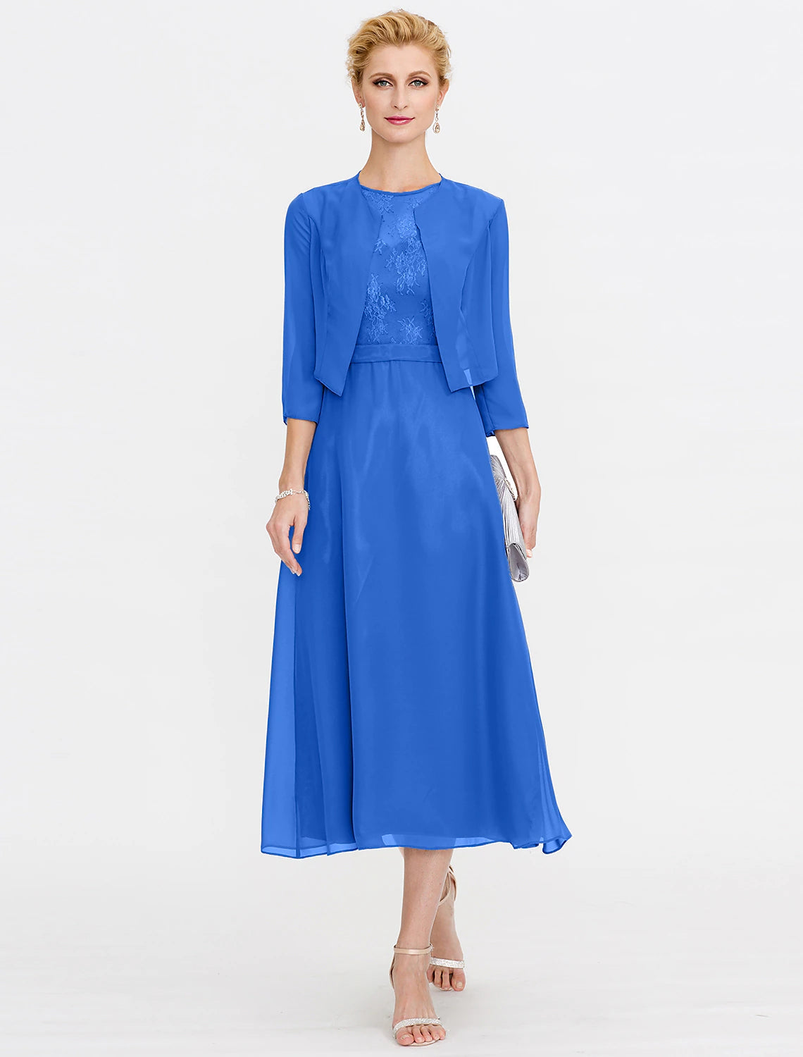Side profile of a woman in a sleeveless tea length dress, showcasing the illusion neckline and pleats.