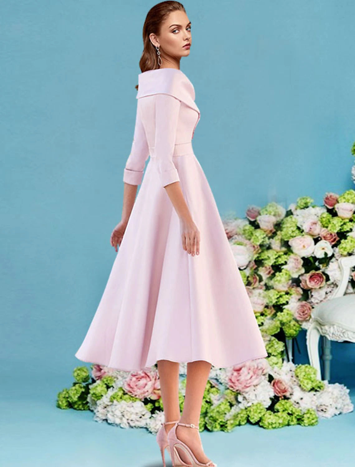 Back view of a woman in an A-line V-neck tea-length satin dress with pleats.
