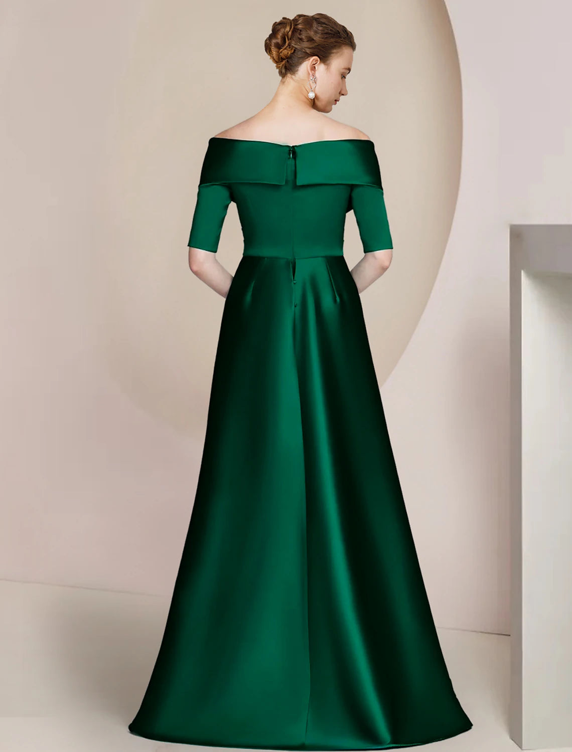 Back view of an elegant off-shoulder satin sheath dress, showing floor-length design and ruching details.