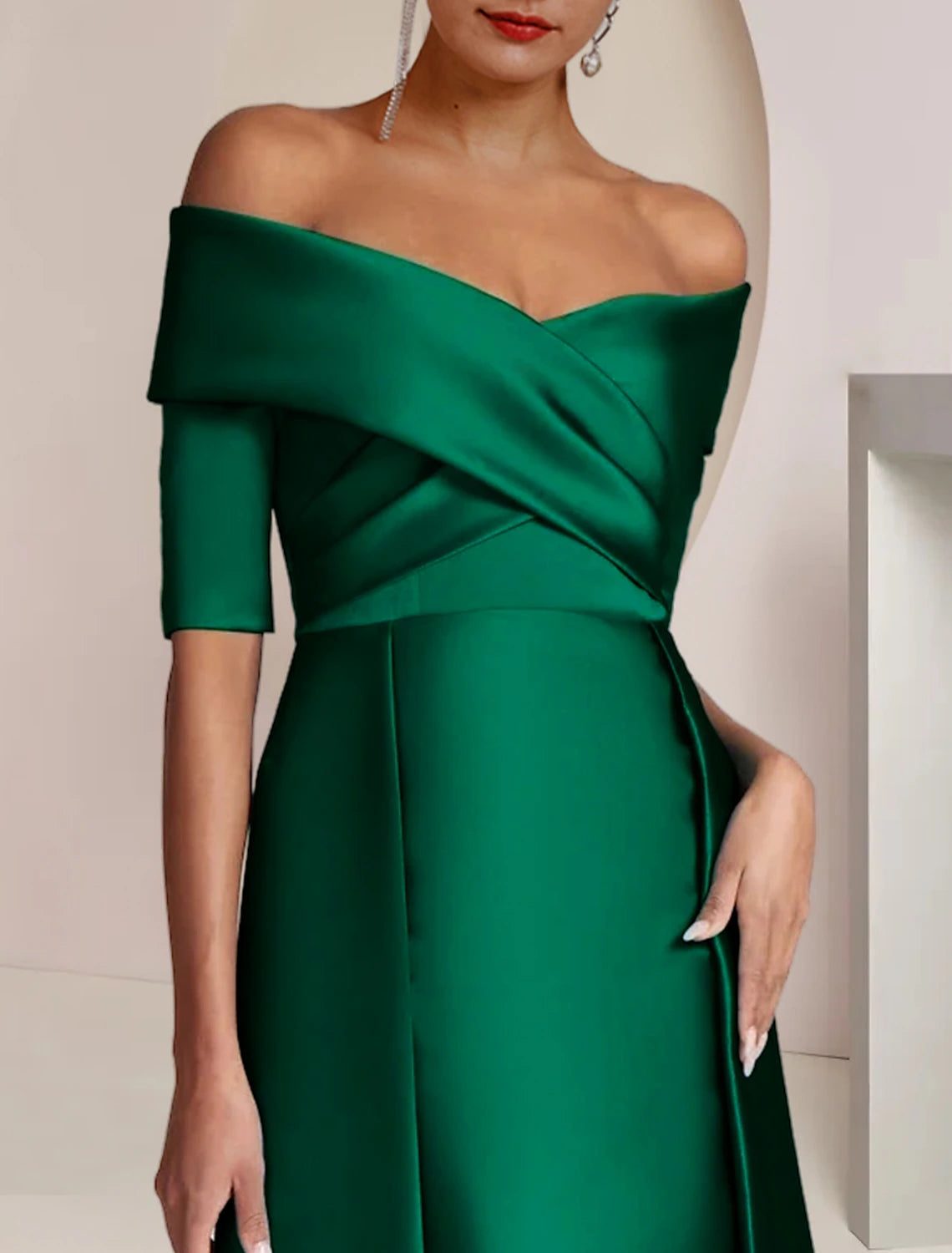 Side view of a woman in an off-shoulder satin Mother of the Bride dress, highlighting the column silhouette.