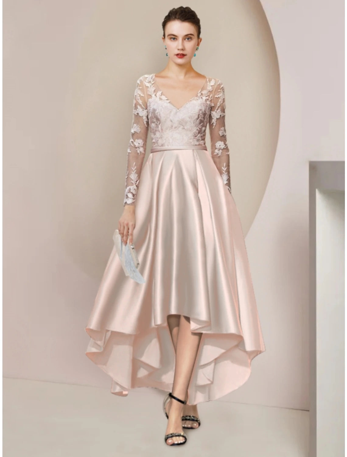 Elegant woman in a V-neck satin sheath mother of the bride dress with long lace sleeves.