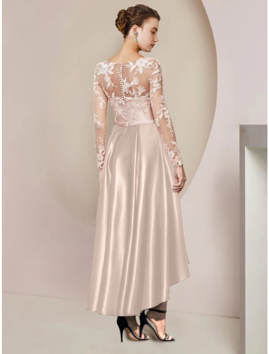 Full length view of an elegant satin sheath dress with lace sleeves, suitable for wedding guests.