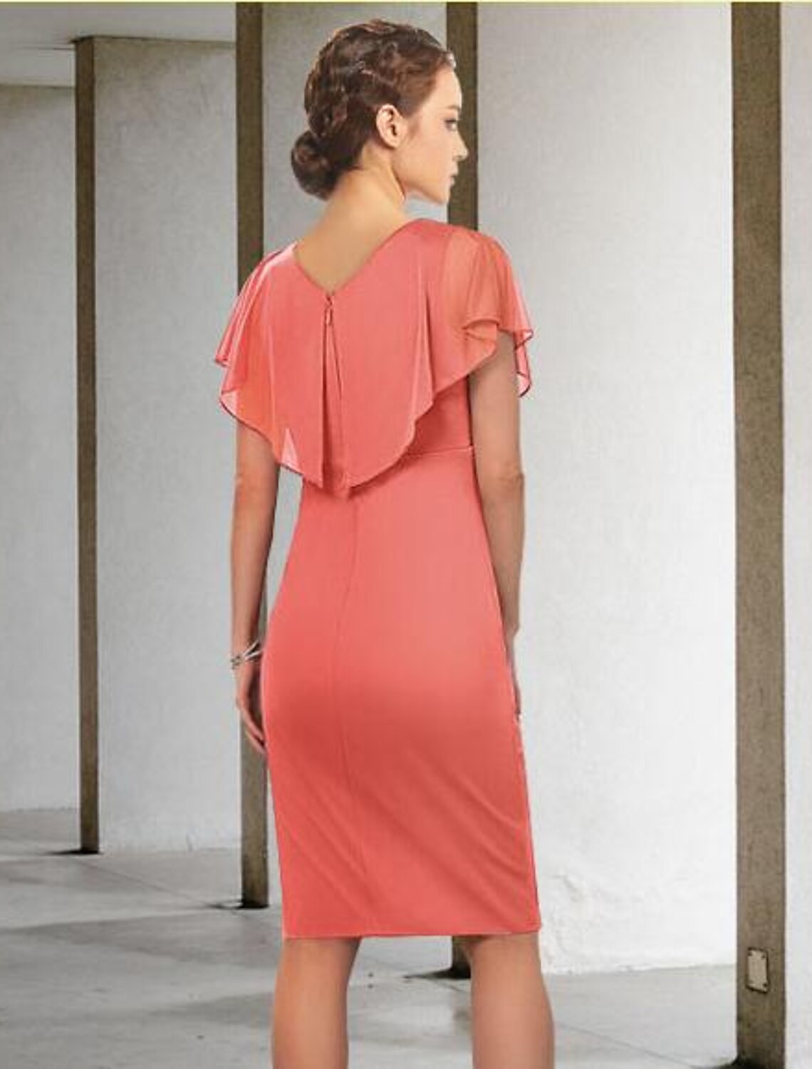 Close-up of the V-neckline and ruched short sleeves on the blue chiffon dress.