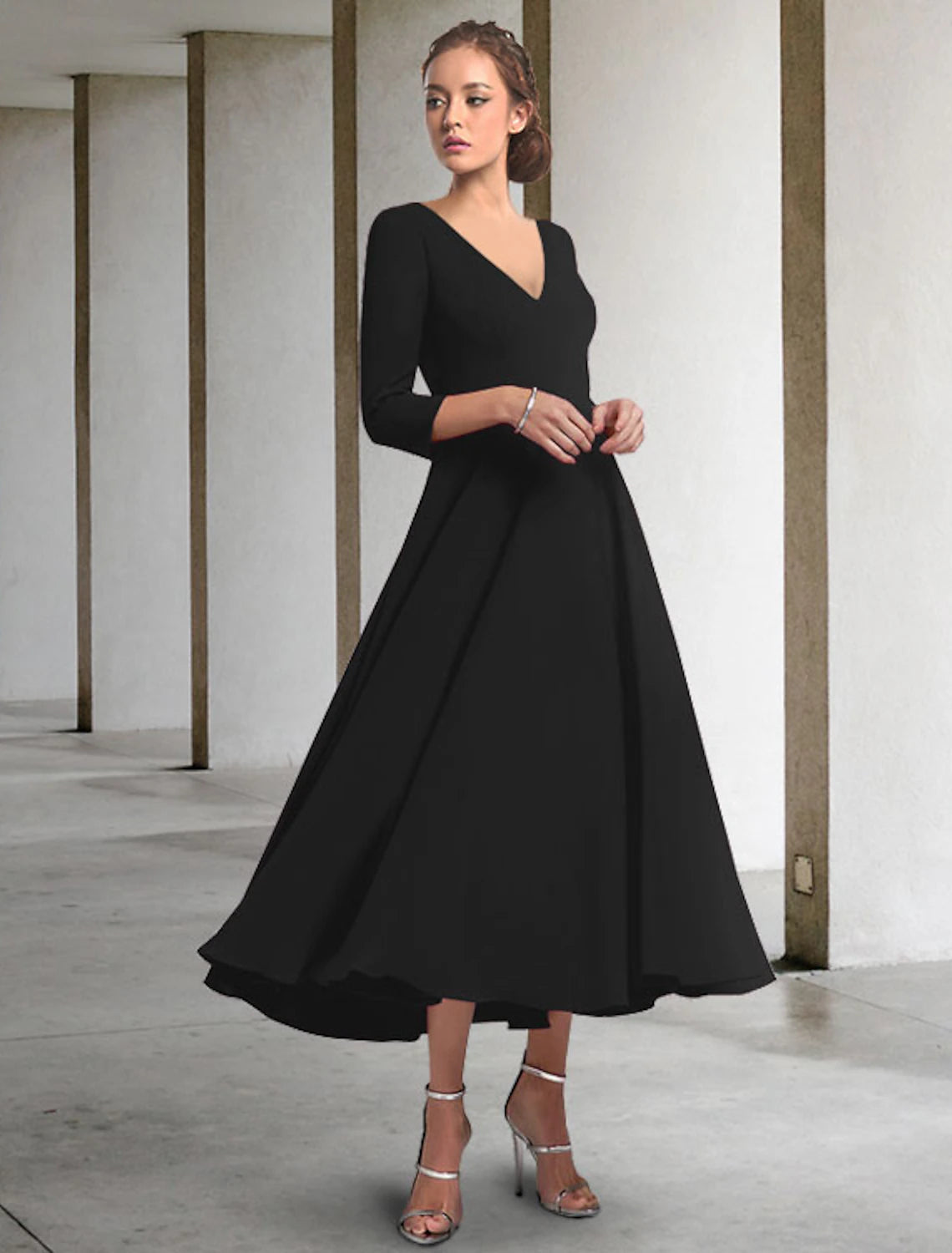 Elegant A-Line Mother of the Bride dress with V-neck, 3/4 sleeves, and tea length in chiffon with pleats.