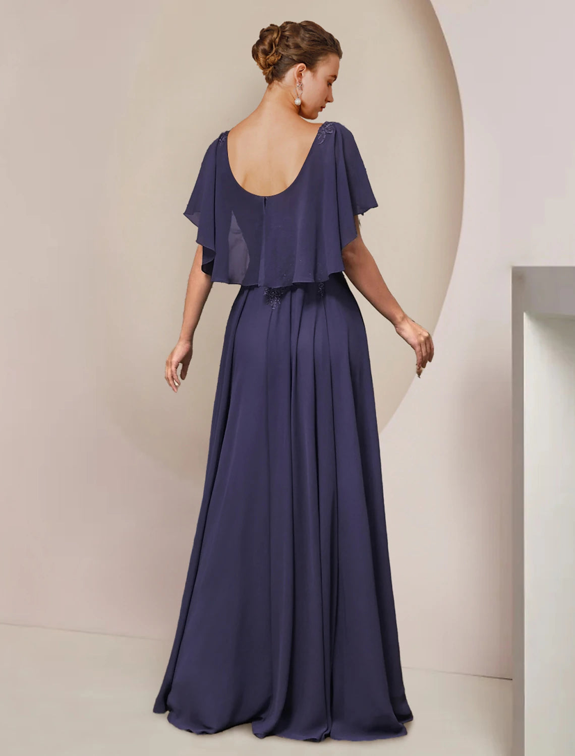 Back view of a floor-length A-line formal dress featuring lace details and pleats.