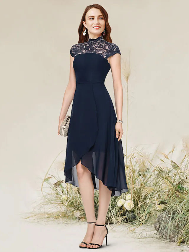 Model wearing a sleeveless A-line cocktail dress with an asymmetrical hem, jewel neck, and lace details.
