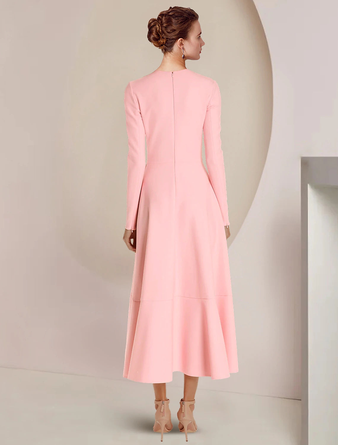 Back view of a woman wearing a formal A-line gown with scoop neck.
