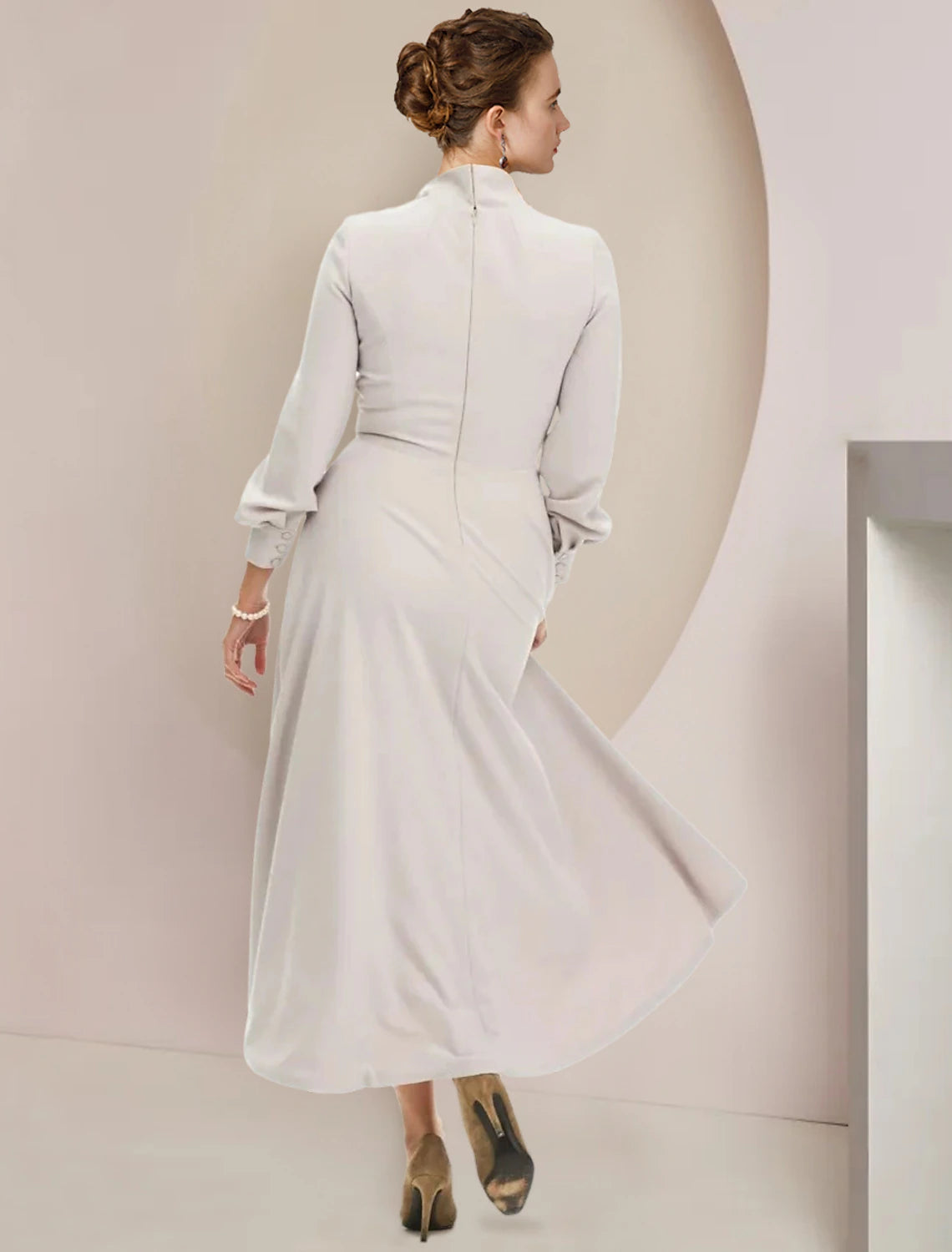 Back view of the A-line tea-length dress showing bow detail.