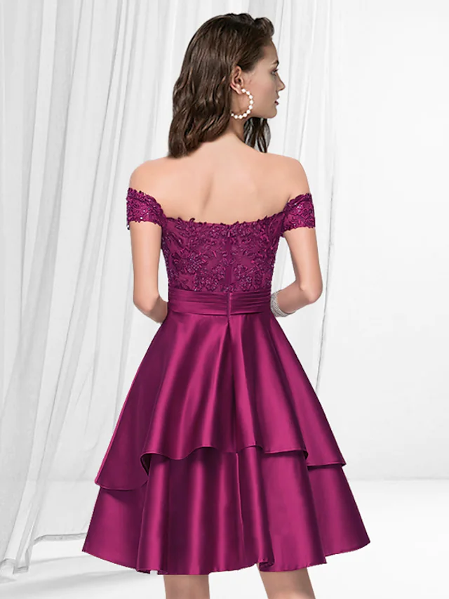 Close-up of the Luolandi off-shoulder satin dress, highlighting the knee-length and pleated details.