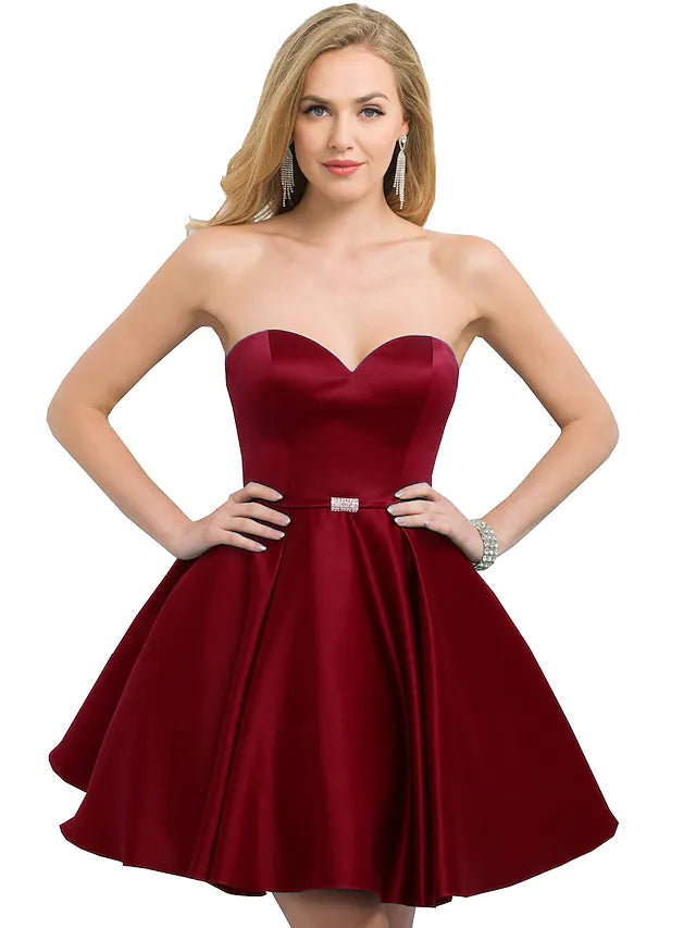 Woman wearing a sleek A-line satin cocktail dress.