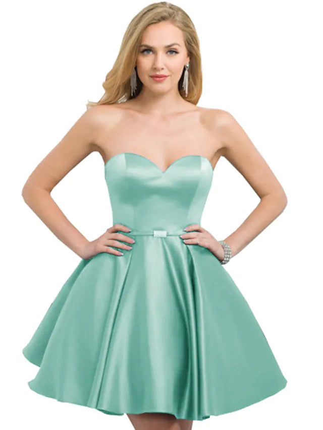 Side view of a woman in a strapless A-line homecoming dress.