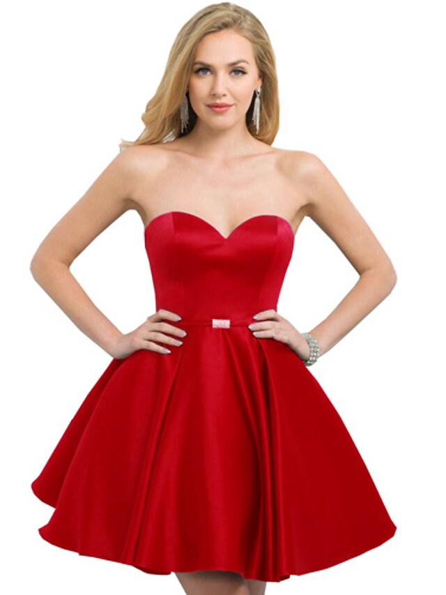 Back view of a woman in a short satin cocktail dress.