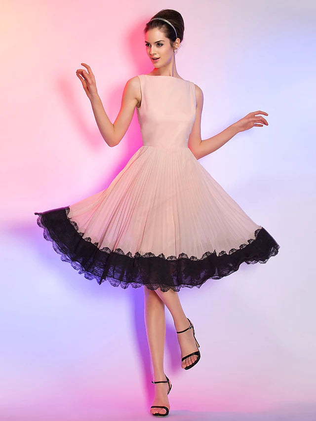Model in a blue A-line knee-length homecoming dress with lace bodice and chiffon skirt.