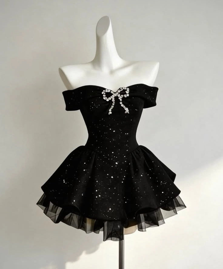 Back view of a black off-shoulder A-line short dress with zipper detail.