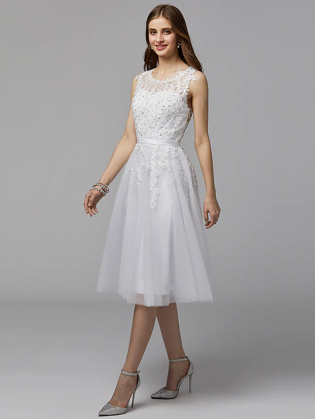 Close-up of the dress's illusion neckline, floral lace pattern, and delicate beading details.