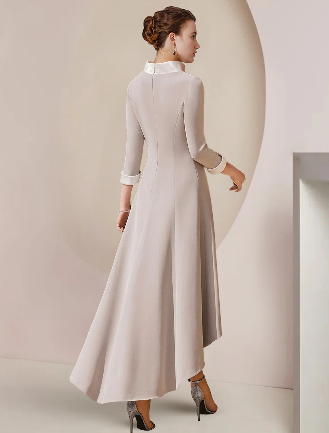 Back view of elegant A-Line tea length satin dress with bow detail.
