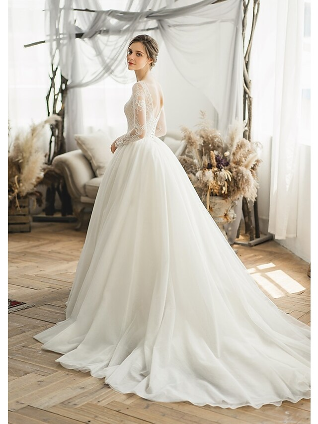 Back view of a bride in a Luolandi ball gown wedding dress showing the chapel train.