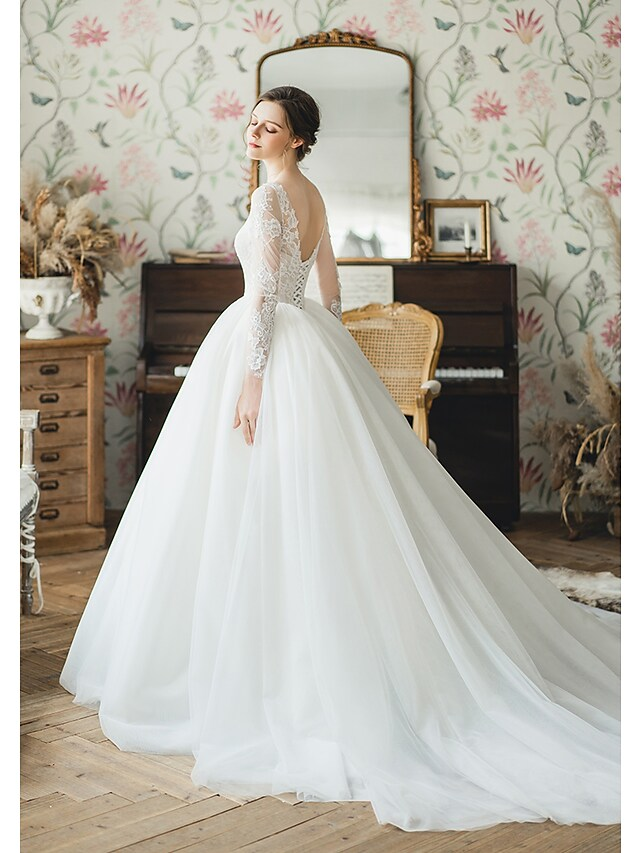 Close-up of the V-neckline and pleated details on the Luolandi wedding dress.