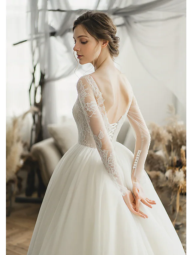 Full length view of the elegant Luolandi wedding dress with a flowing chapel train.