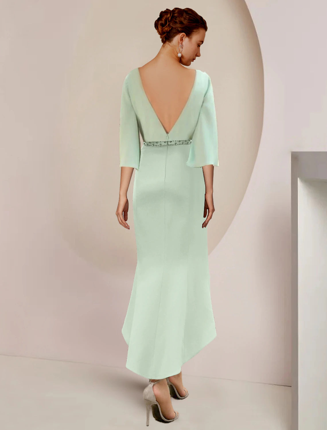 Side view of a tea length chiffon mermaid dress with beading.
