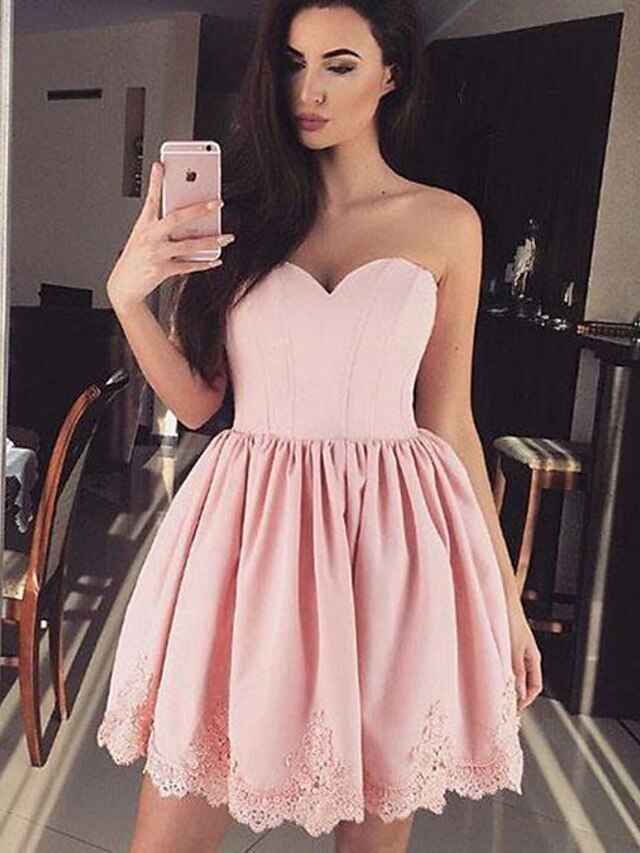 Woman wearing a Luolandi A-Line ball gown homecoming dress in Italy satin.