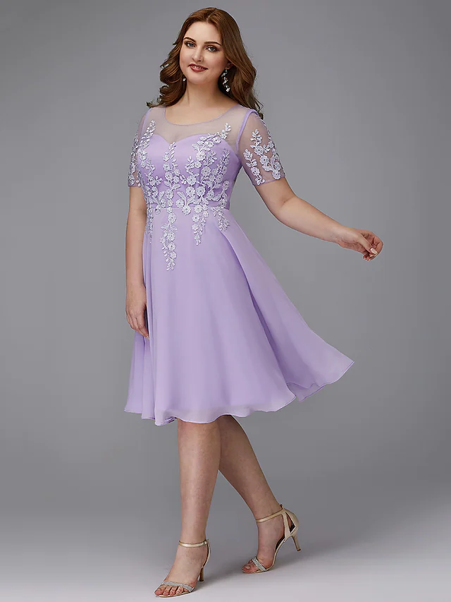 Model wearing a Luolandi A-line plus size homecoming cocktail dress with illusion neck and short sleeves.