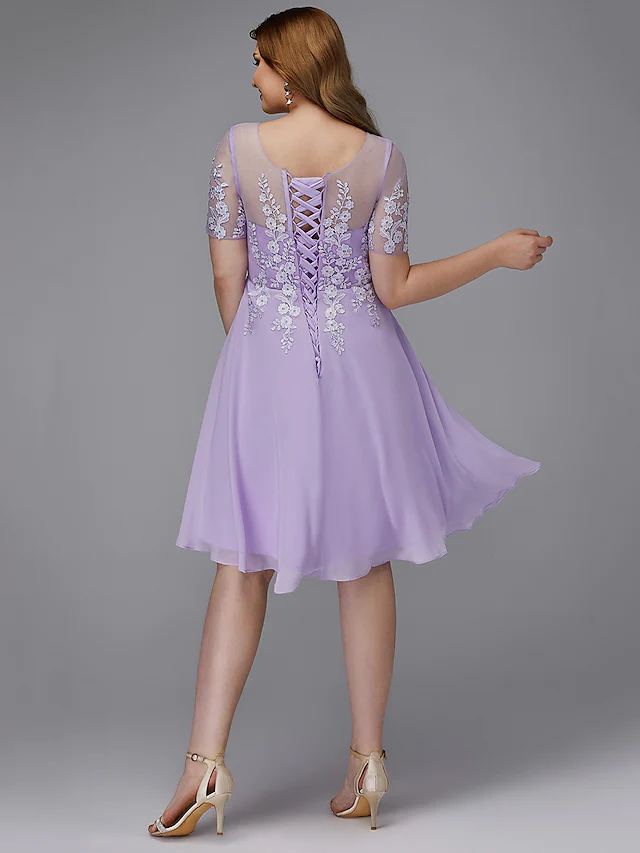 Close-up of the illusion neckline and lace appliques on the A-line plus size dress.