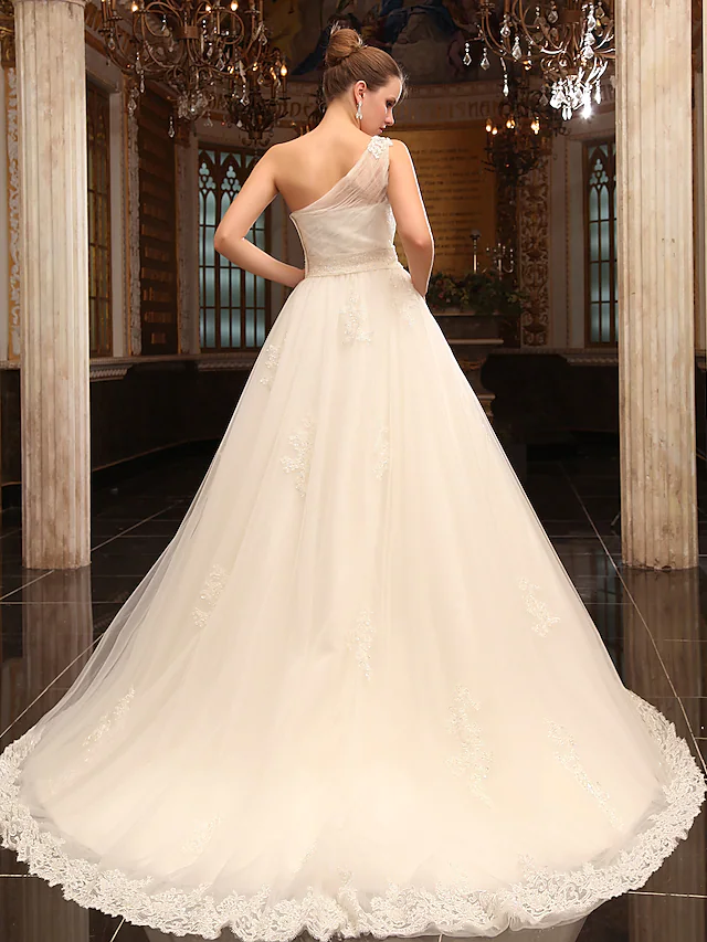 Close-up of the one-shoulder neckline and satin fabric.