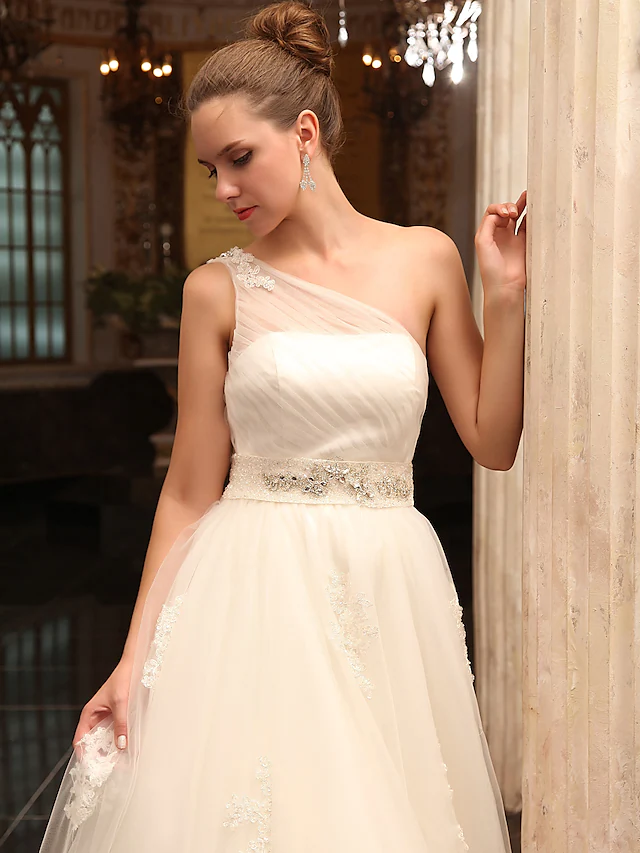 Bride wearing a sleeveless A-line wedding dress.