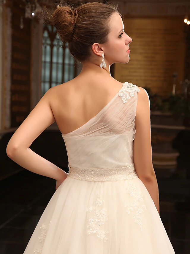 Full length view of a white princess wedding gown.