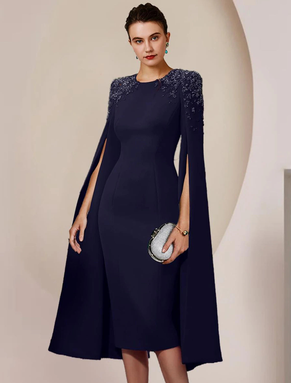 Back view of the knee-length chiffon Mother of the Bride Dress with delicate beading.