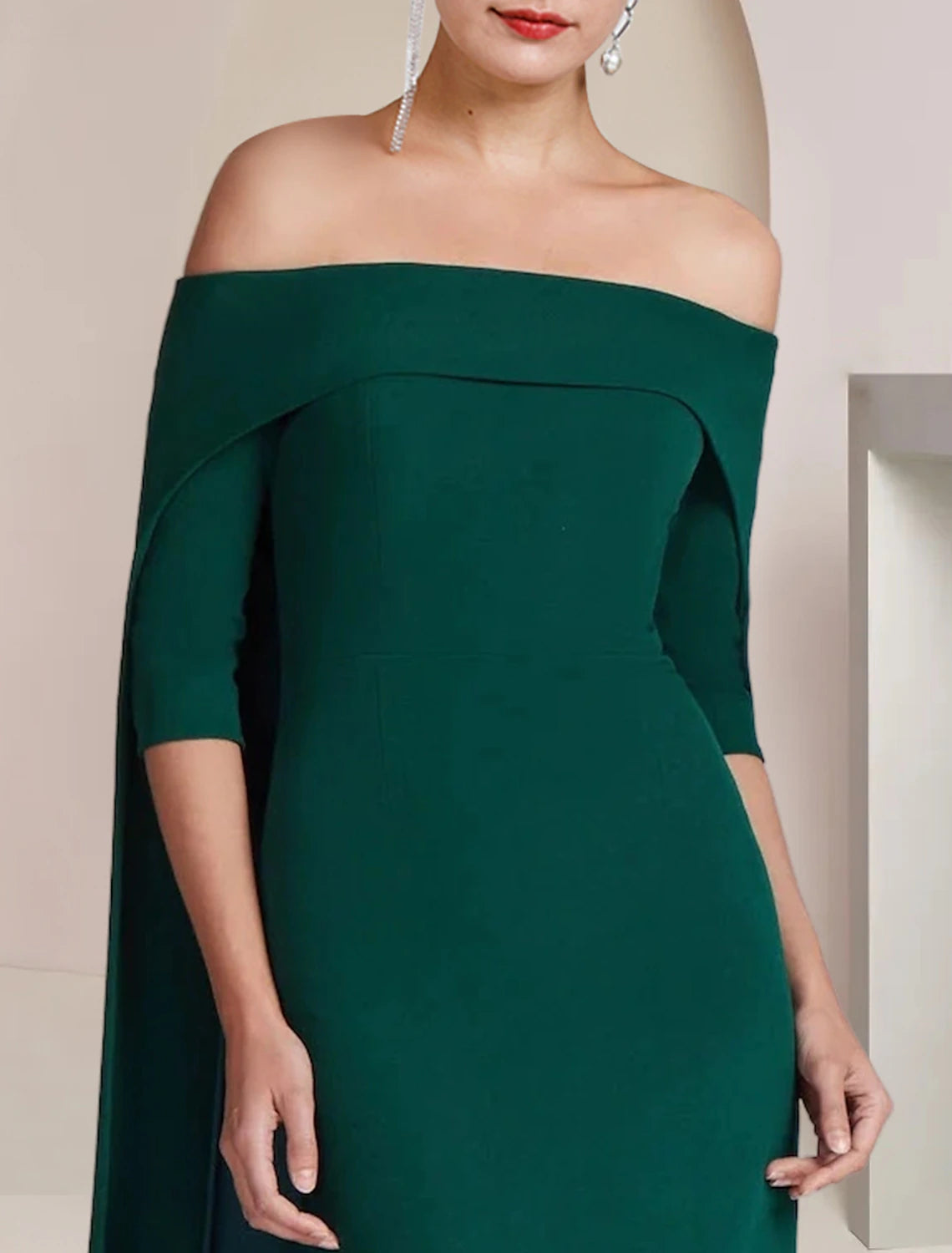 Detail of the elegant strapless neckline and half sleeves on the gown.