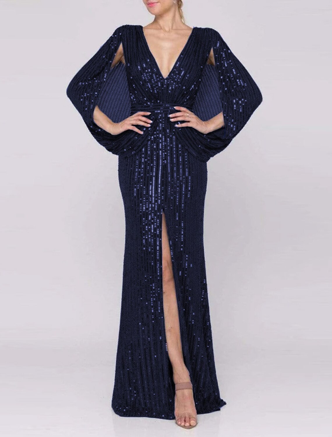 Model wearing a sparkling mermaid trumpet evening gown with a V-neck and front slit.
