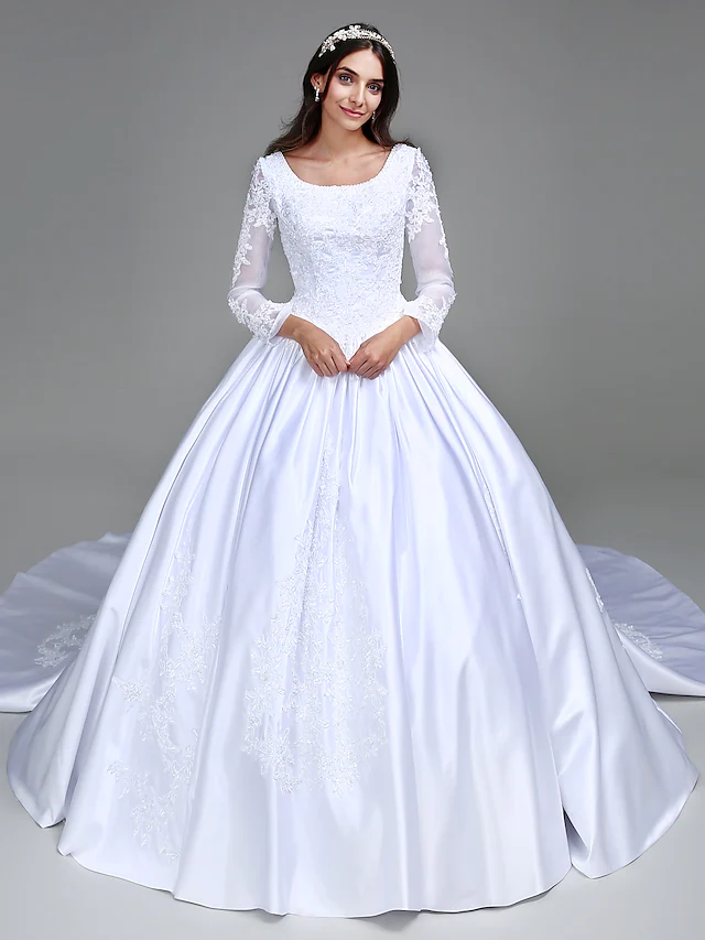 Model wearing Luolandi vintage ball gown wedding dress with scoop neck and long sleeves, front view.