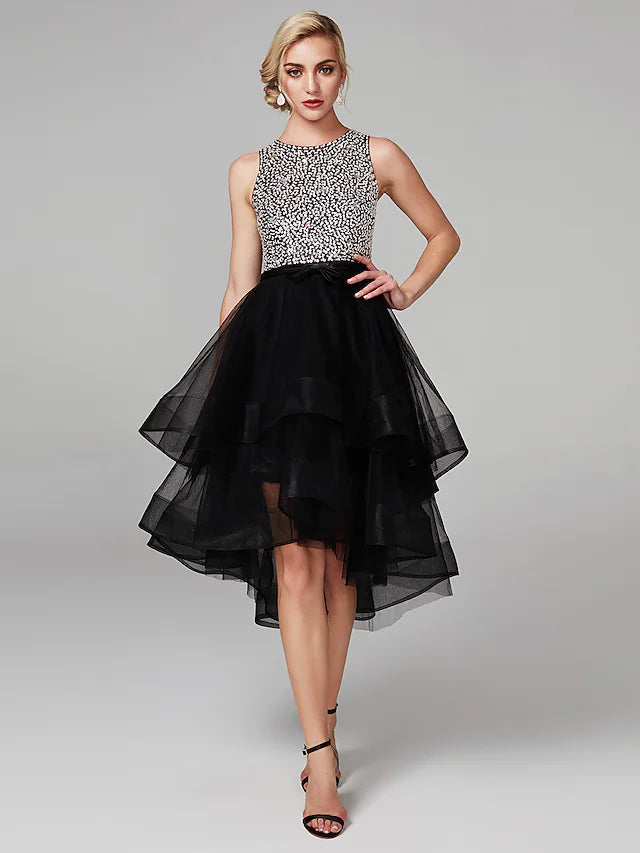 Model wearing a black knee-length satin ball gown with beading and cascading ruffles.