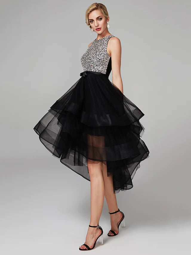 Side view of a model in a black knee-length satin ball gown with beading.