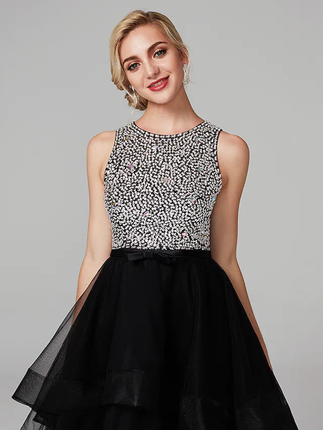 Back view of a black knee-length satin ball gown showing cascading ruffles.