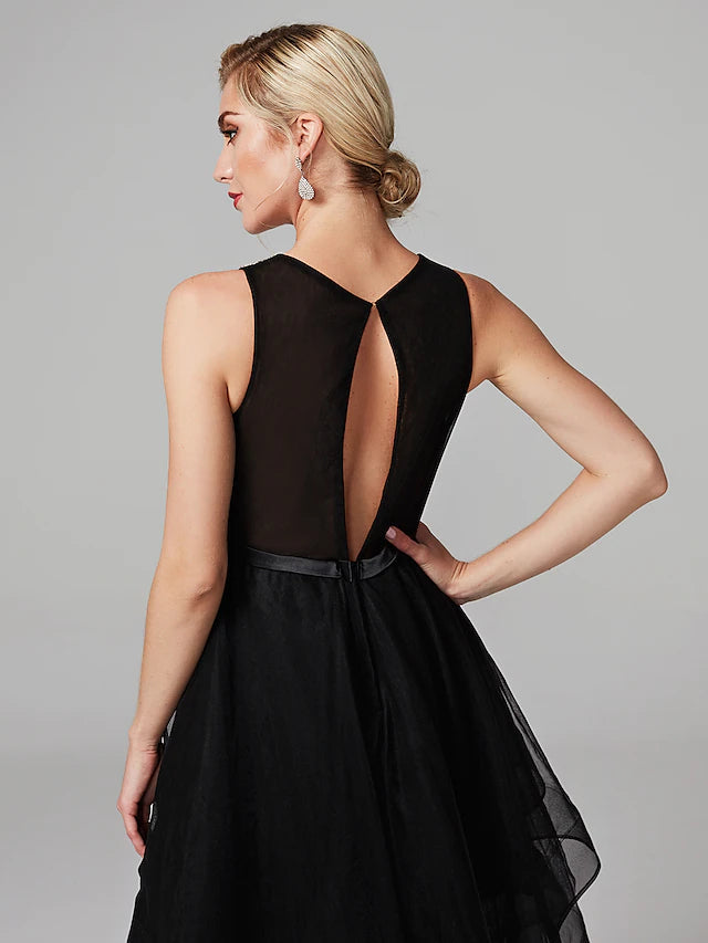 Close-up detail of the beading and satin fabric on the black dress.