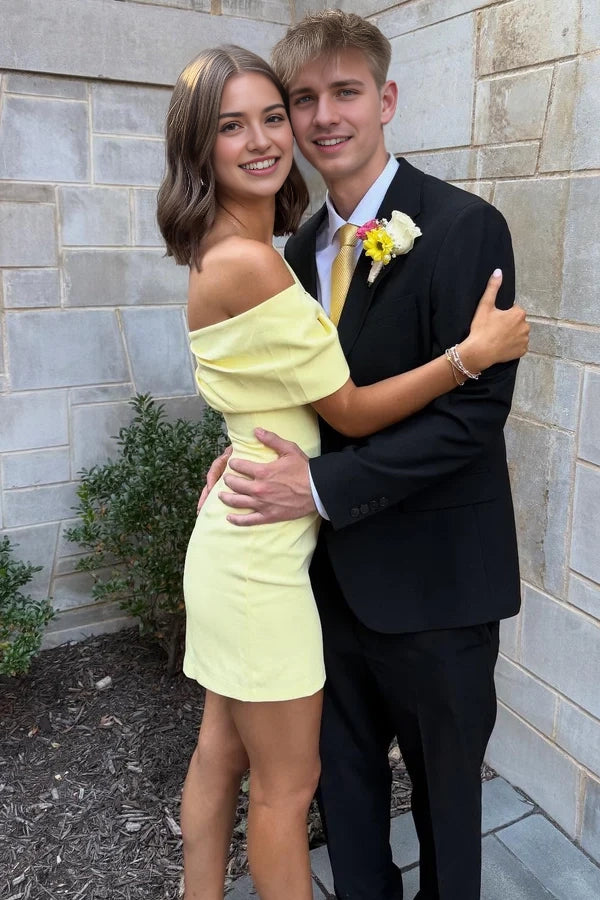 Model posing in a yellow off-shoulder sheath short dress, back view.